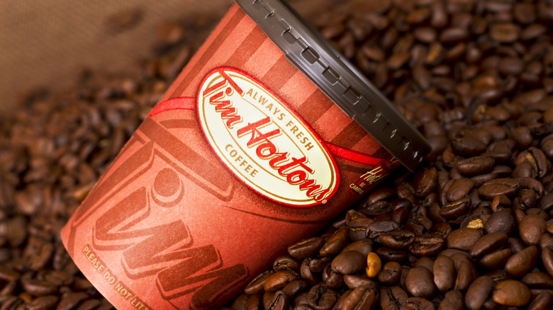 Tim Hortons cup on pile of coffee beans