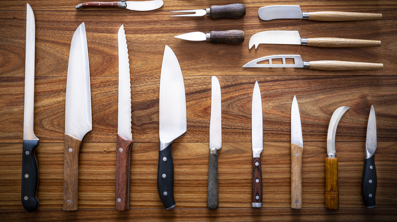 different types of knives on a wooden table