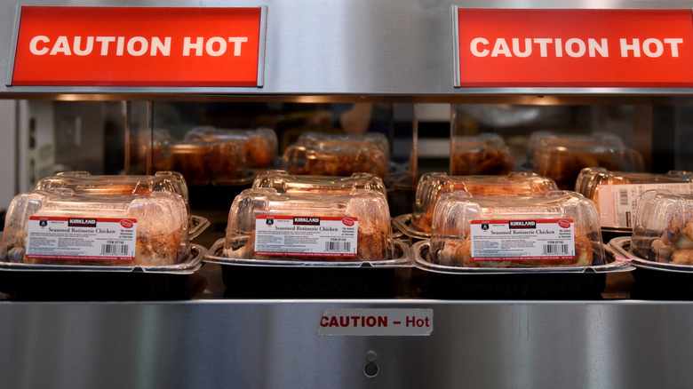 Clamshells of rotisserie chicken at Costco on rack