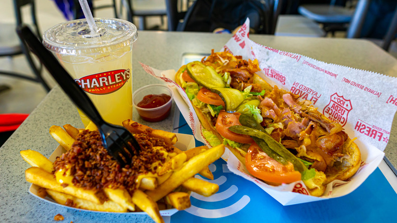 A Charleys Philly cheesesteak meal with fries and lemonade