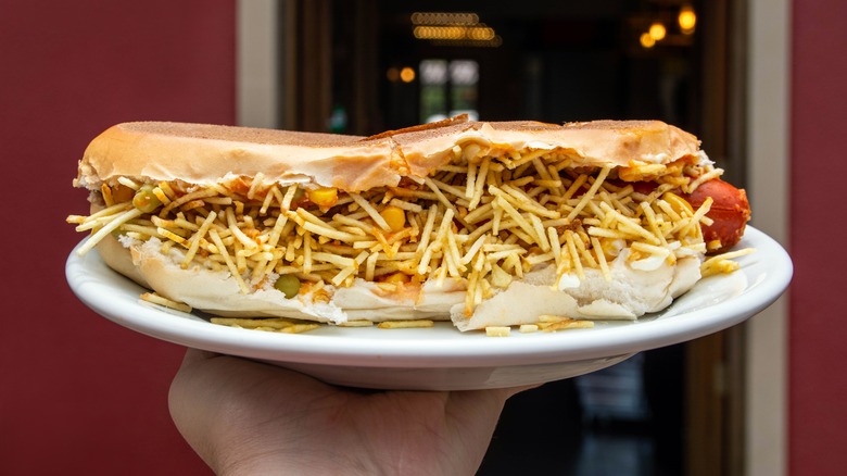 hand holding Brazilian hot dog