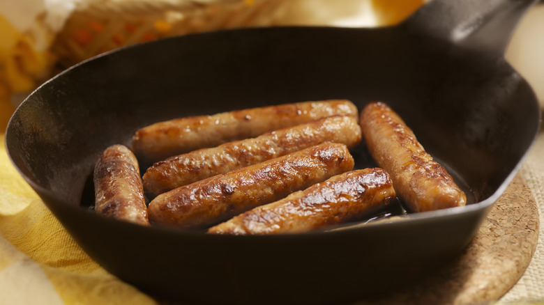 Breakfast sausage cooking in pan