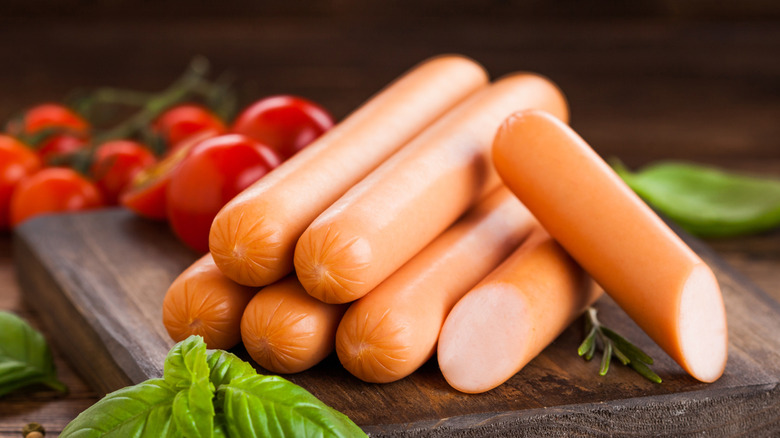 Steamed hot dogs on a cutting board