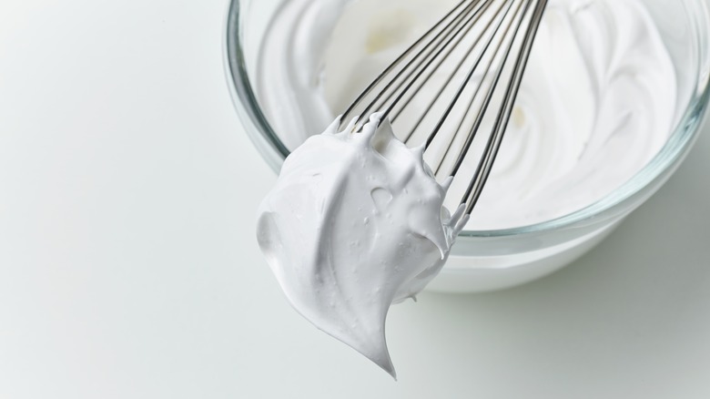 Egg white meringue on whisk