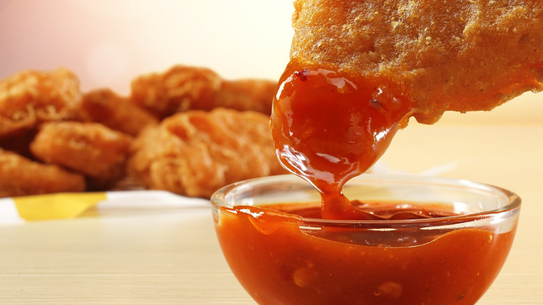 McDonald's nuggets dipped in Mighty Hot Sauce.