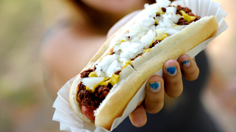 Coney island dog held in someone's hand