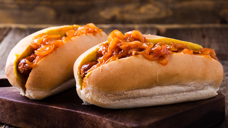two hot dogs with onion sauce on top