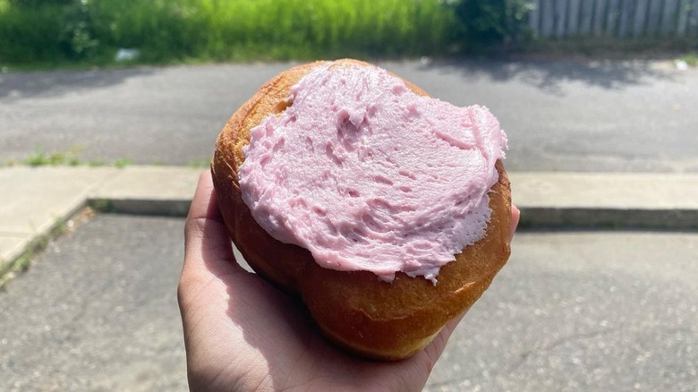 Person holding a Persian donut