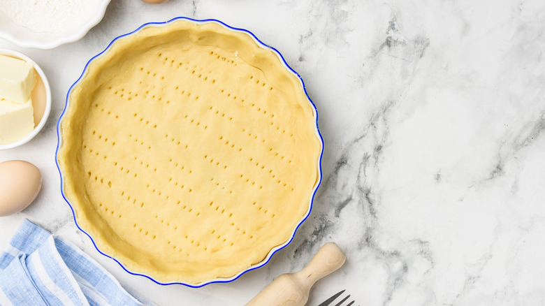 Raw quiche dough in tart pan