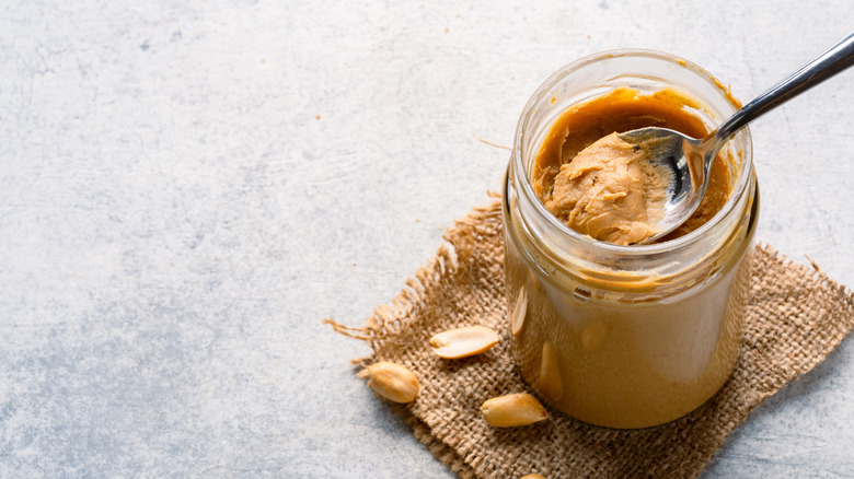 A spoon in a peanut butter jar.