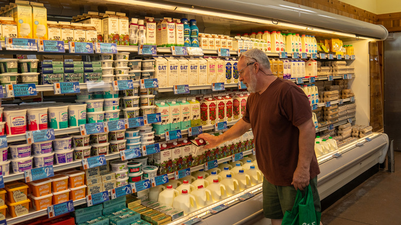 A male shopper browses a refrigerator case at Trader Joe's