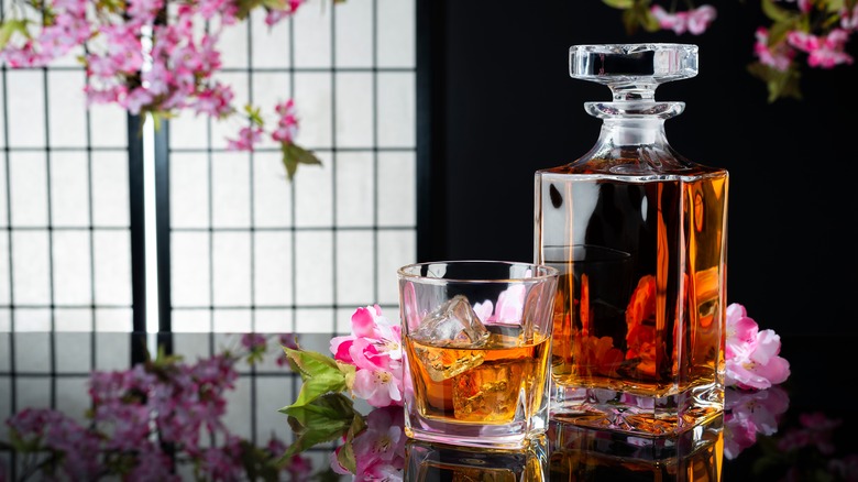 Bottle and glass of Japanese whisky with cherry blossoms