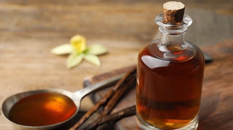 Jar of vanilla extract with beans and orchid