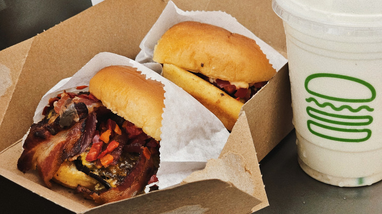 Two Shake Shack burgers and a drink.