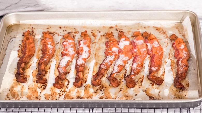 Bacon strips on parchment lined sheet pan