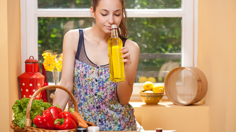 Woman smelling olive oil