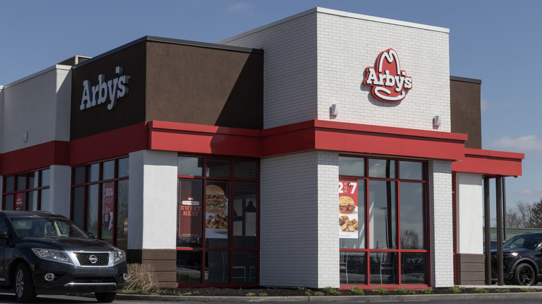 Outside of an Arby's restaurant with car in drive thru