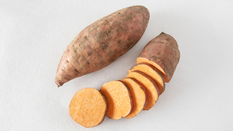 Whole sweet potato and one that's been sliced