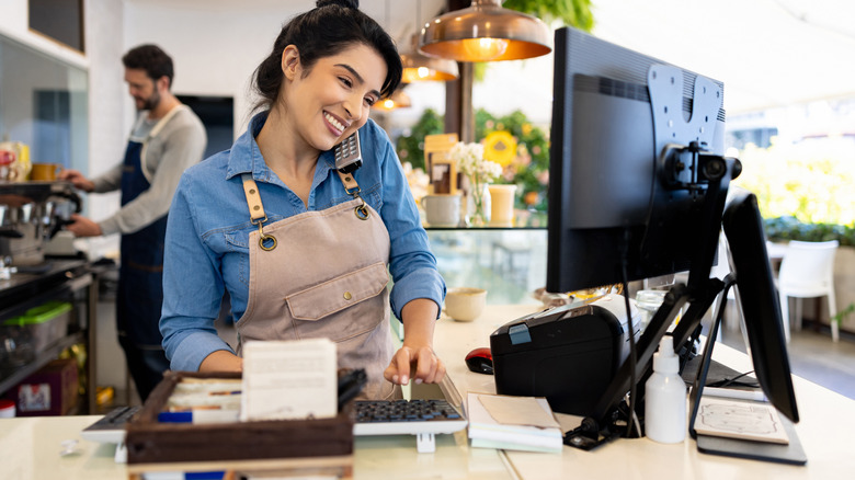 woman taking restaurant reservations