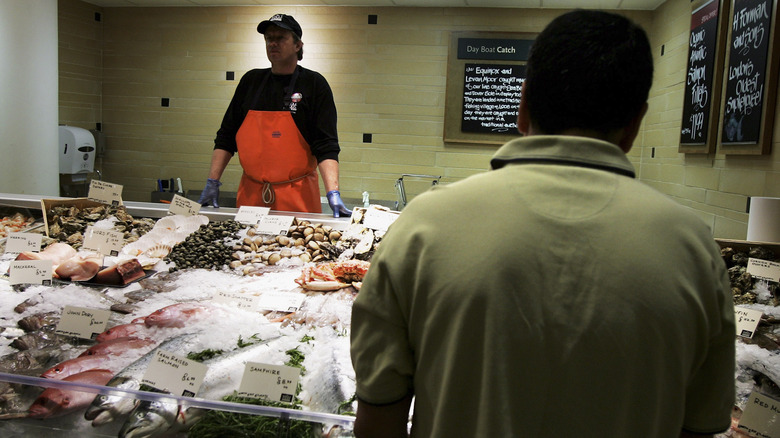 person ordering at a seafood counter