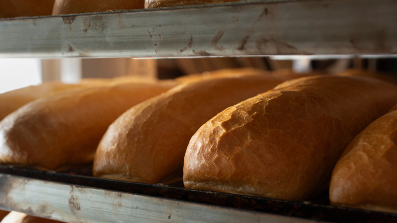 Close up of bread loaves on bakery rack.