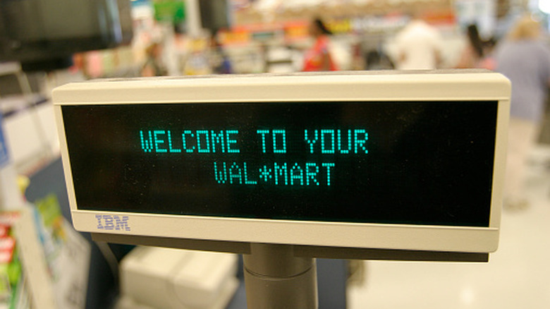 A vintage IBM monitor displays a message reading "Welcome to your Wal-Mart"