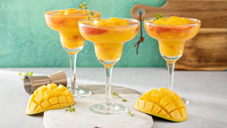 Three blended mango and chili margaritas