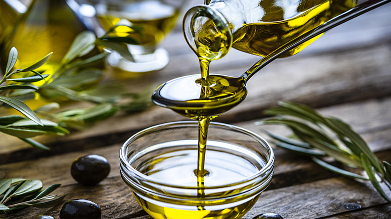 Olive oil dripping onto spoon