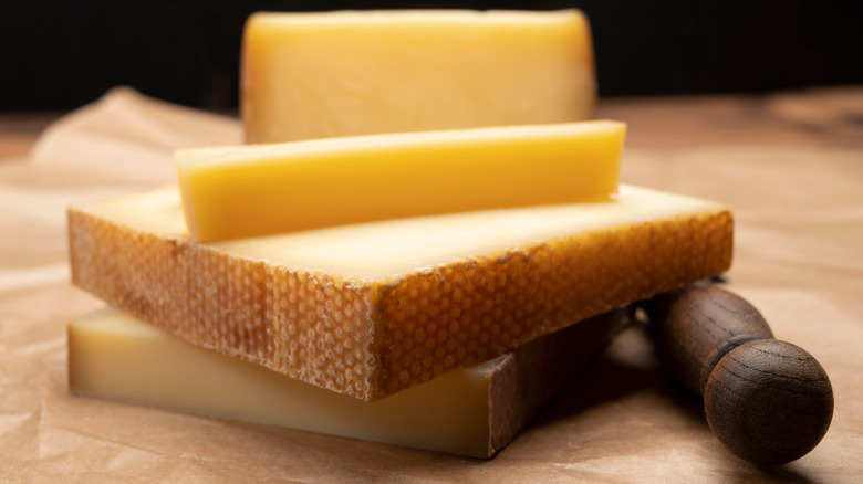 Close up of thick slices of Gruyère cheese on wooden surface