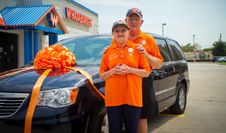Karl and Carol Hoepfner pose with their new minivan after completing their tour of every Whataburger location.