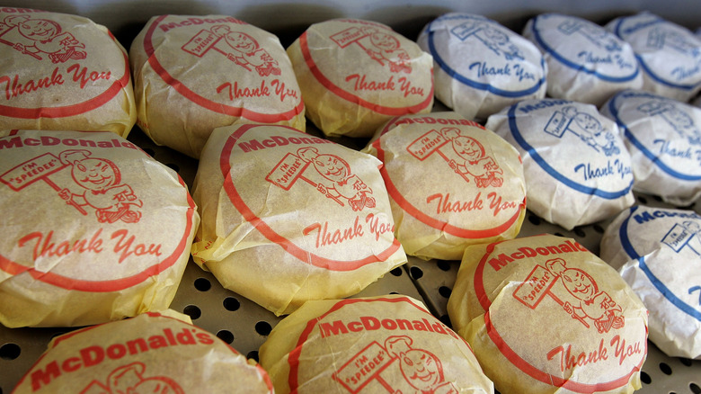 Many wrapped McDonald's burgers.