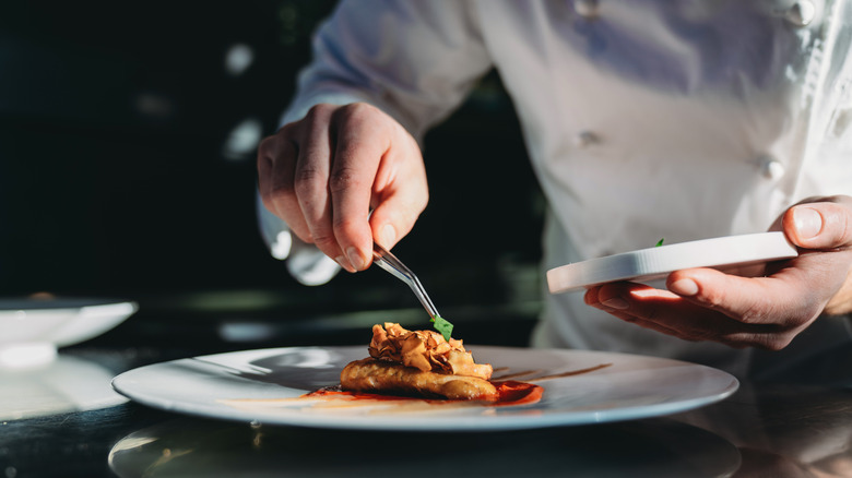 A chef preparing an elegant dish.