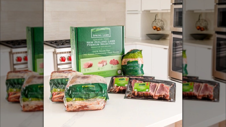 The contents of a box of assorted lamb cuts sit on a counter.