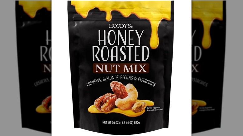 A bag of honey roasted nuts sits against a white background.