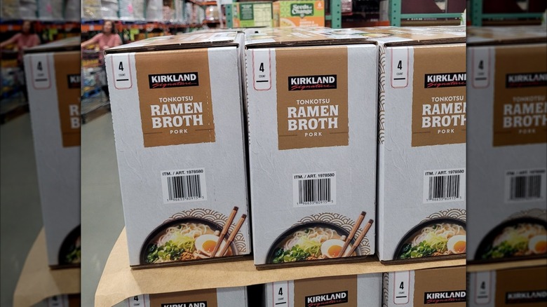 Boxes of pork ramen broth sit on a display in a Costco.