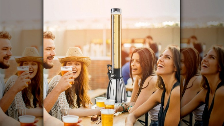 An Oggi beer tower looms over a group of friends