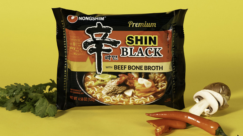 Nongshim Shin Ramyun Black noodle pack surrounded by ingredients