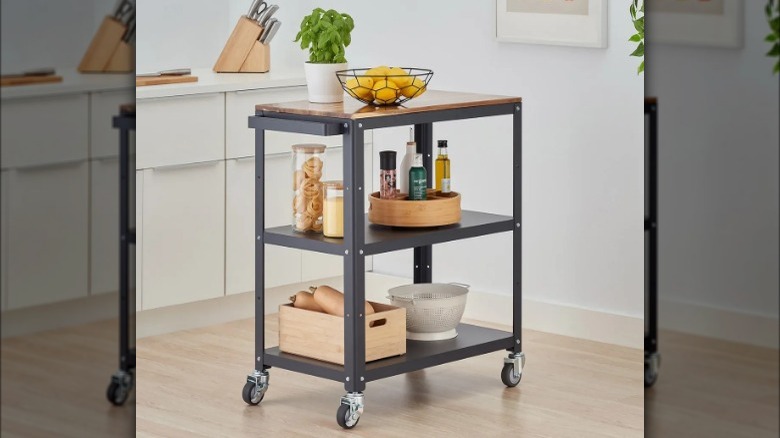A three-tiered kitchen cart in a kitchen