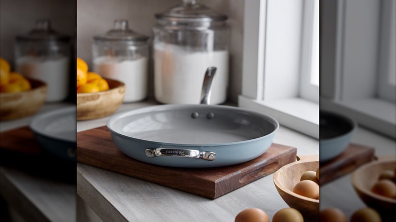 The GreenPan rests on a wooden cutting board in a kitchen