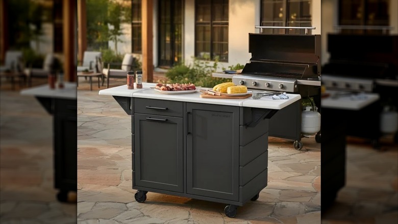 The Suncast Outdoor Prep Station with Storage on an outdoor patio