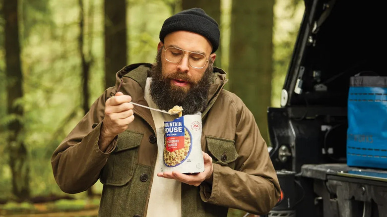 person eating Mountain House beef lasagna flavored pasta