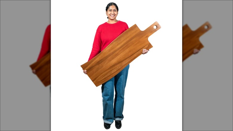 A person holds up the Sango XL Charcuterie Board