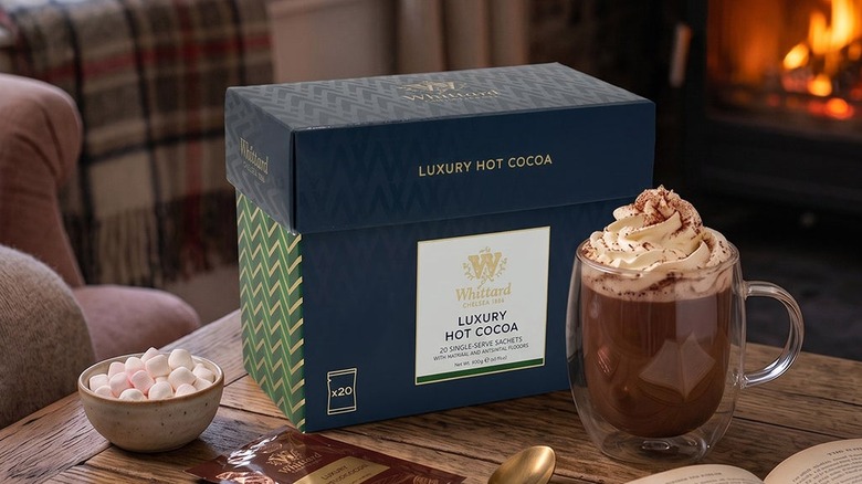 A box of Whittard hot cocoa sits on a living room table.