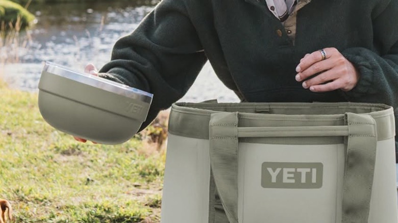 A camper sets down a Yeti bowl.
