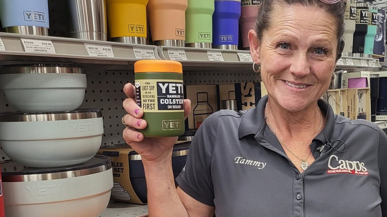 A worker at Capps holds a YETI can colster.