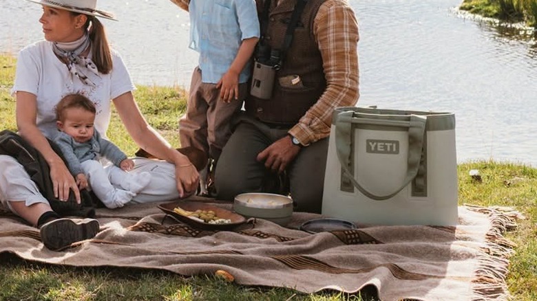 A YETI tote bag sits on the ground.