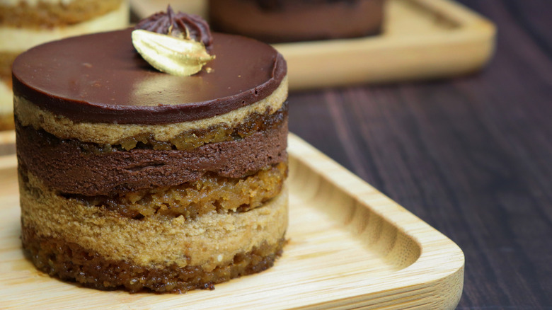Gluten-free French opera cake on a wood plate