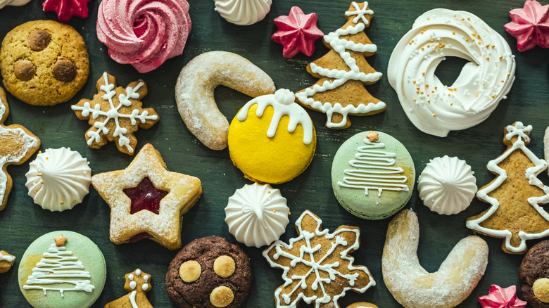 Assorted Christmas cookies sit on a green table