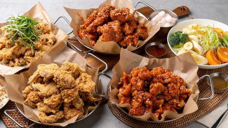 Different styles of Korean fried chicken in serving trays