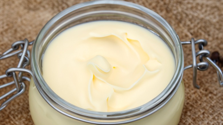 Jar of beef tallow on brown background